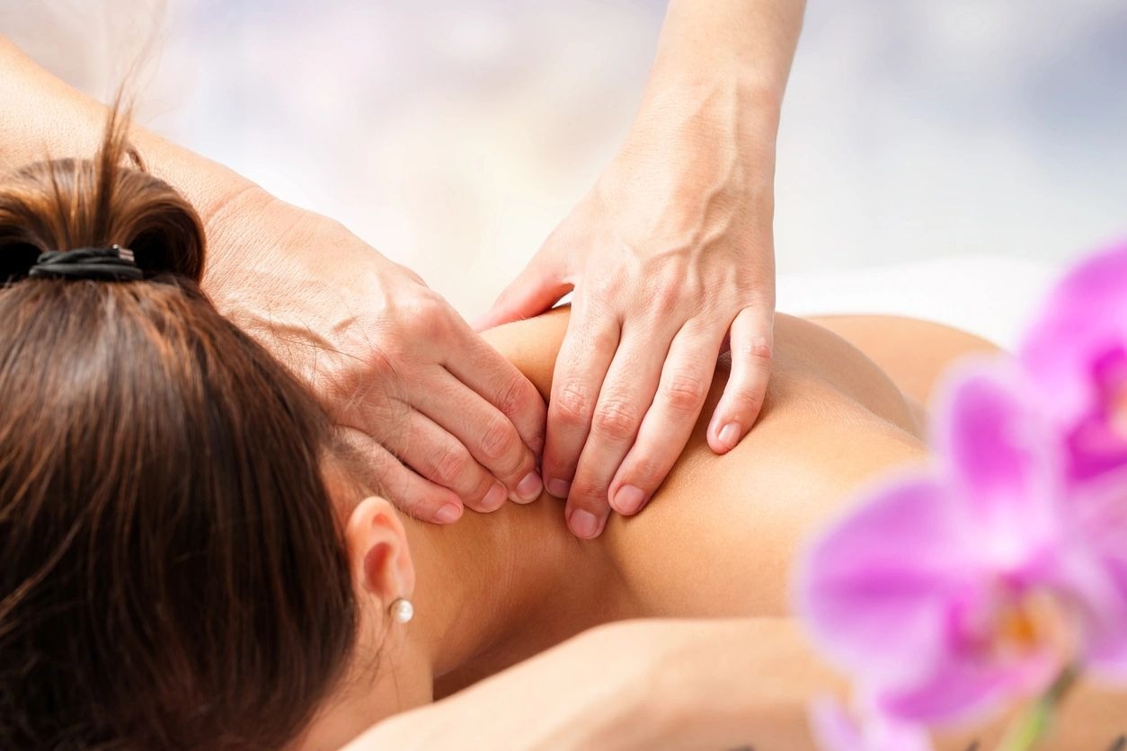 Detail of hands massaging female neck